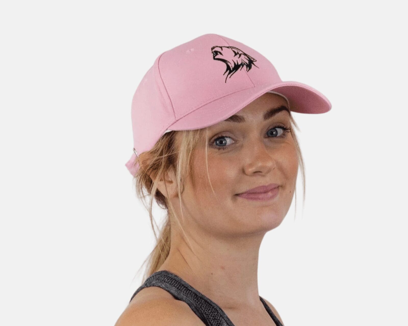A woman wearing a pink hat with an animal on it.