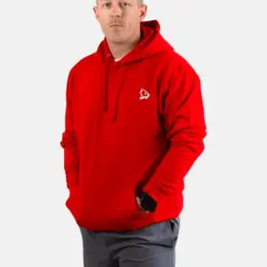 A man wearing a red hoodie with his hands in his pockets.