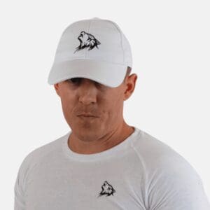 A man wearing a white hat with an animal on it.