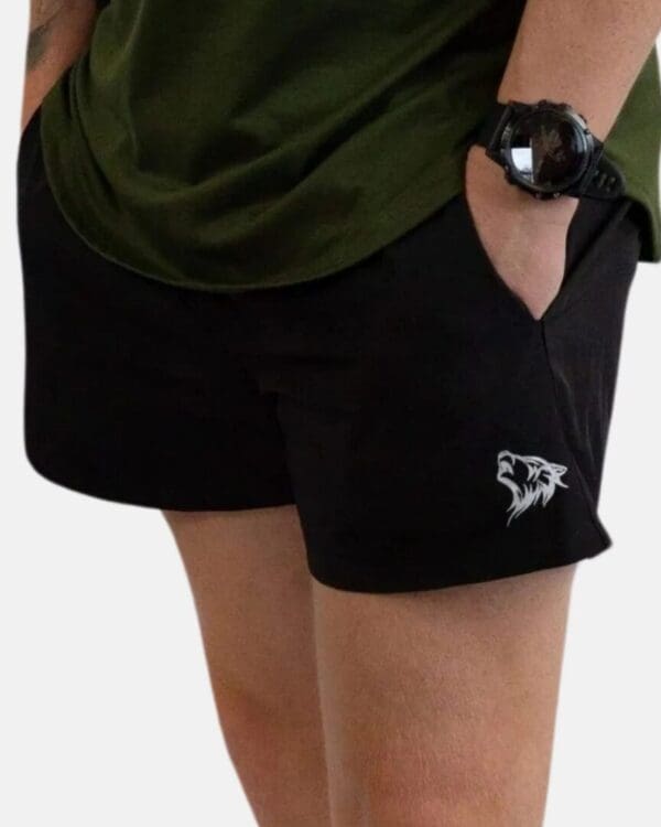 A person wearing black shorts and green shirt.