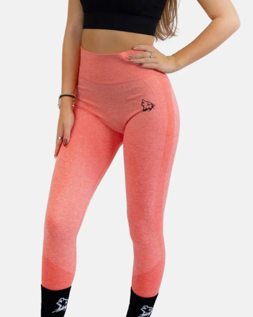 A woman wearing pink leggings and a black bra
