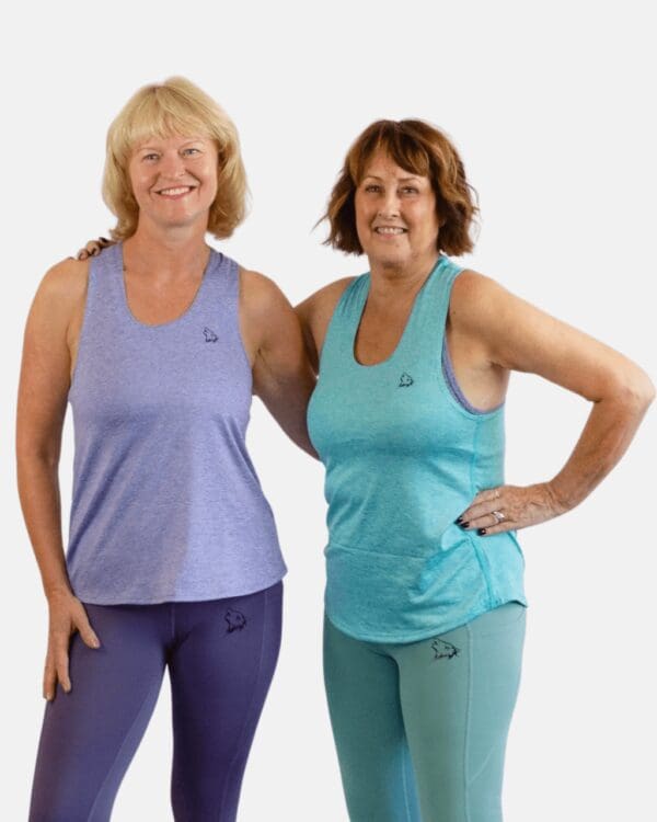 Two women standing next to each other in blue clothes.