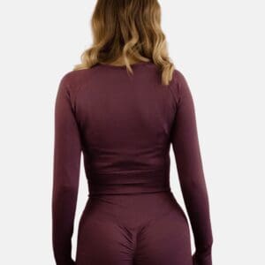 A woman in purple long sleeve shirt and pants.