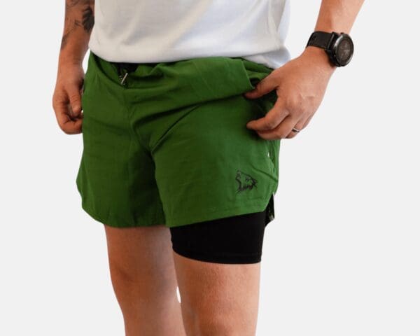 A man wearing green shorts and white shirt.