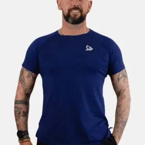 A man with tattoos wearing blue shirt and black pants.