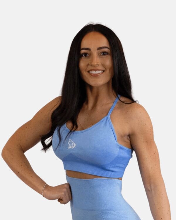 A woman in blue top posing for the camera.