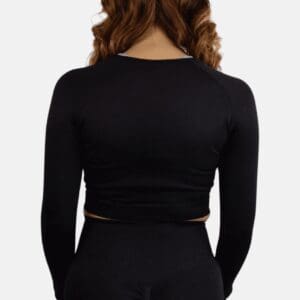 A woman wearing black long sleeve top and black pants.