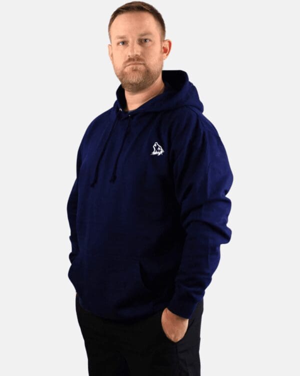 A man wearing a navy blue hoodie with a white logo.