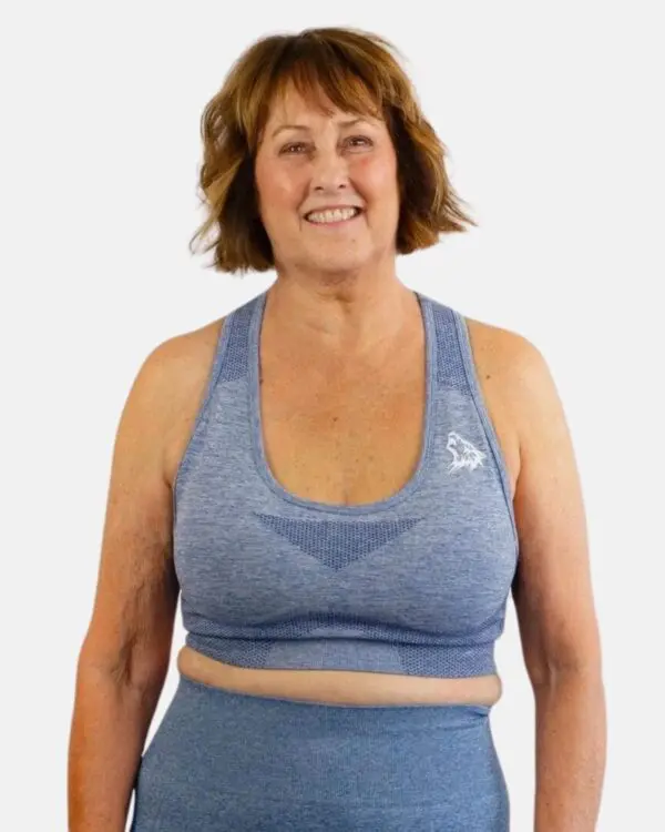 A woman wearing a blue sports bra and leggings.