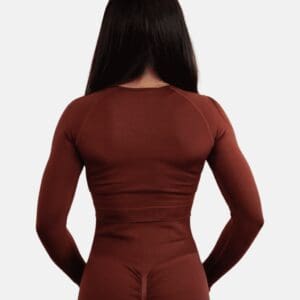 A woman in a brown shirt and black pants