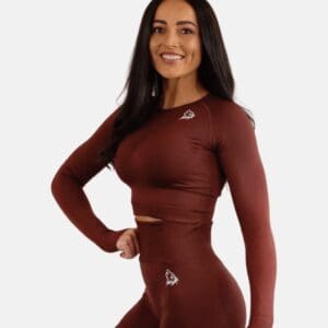 A woman in maroon long sleeve top and leggings.