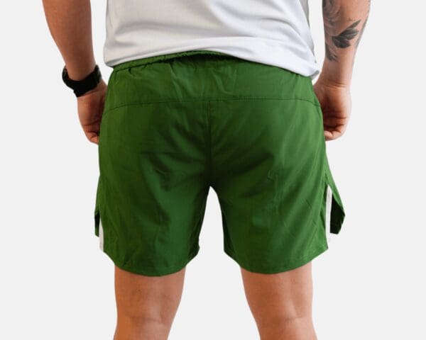 A man wearing green shorts and white shirt.