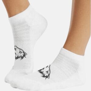 A person wearing white socks with wolf heads on them.