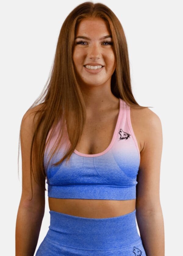 A woman wearing a blue and pink sports bra.