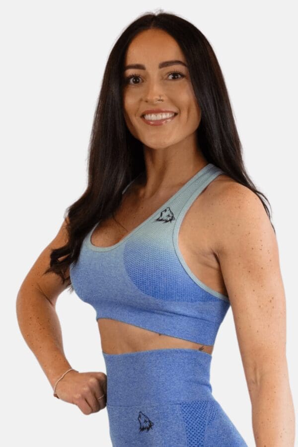 A woman in blue sports bra and leggings.