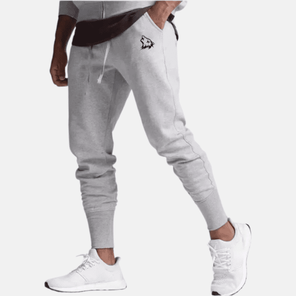 Man wearing gray sweatpants with wolf logo.